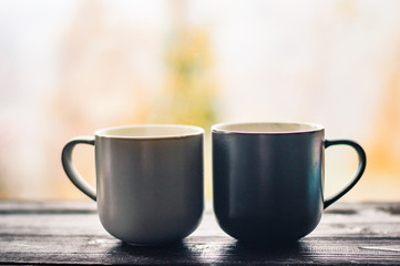 Still life with cup of coffee on the carpathian mountains background during the sunset