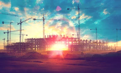 Fototapete Industriegebäude Sonnenuntergang Landschaft. Baukräne und Gebäude