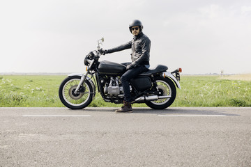 Motorcyclistor rider looking directly at the camera, ready to ride