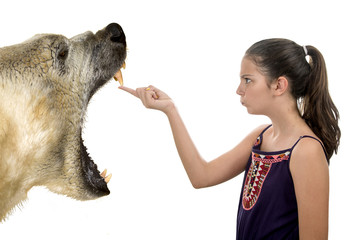 Young fearless girl with a polar bear on a white background