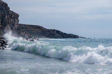 beautiful wild beach with black sand