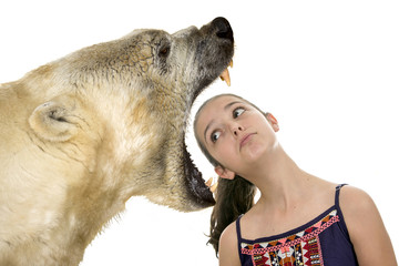 Young fearless girl with a polar bear on a white background