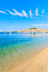 View of beautiful beach with crystal clear turquoise water in Primosten town, Dalmatia, Croatia