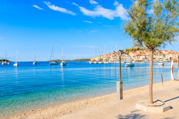 View of beautiful beach and coastal promenade in Primosten town, Dalmatia, Croatia