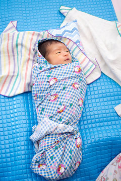 Asian Baby Wrapped With Blanket