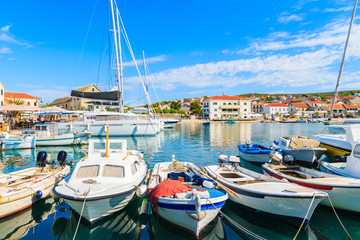 Fototapeta na wymiar Fishing boats mooring in beautiful Primosten port, Dalmatia, Croatia