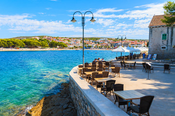 PRIMOSTEN PORT, CROATIA - SEP 5, 2017: Restaurant tables in Primosten old town port, Dalmatia, Croatia.