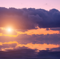 Sunset from storm clouds over the sea.