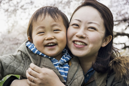 Asian mother and toddler family portrait in spring