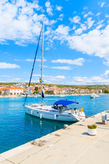 Fototapeta na wymiar Sailing boat anchoring in Primosten port, Dalmatia, Croatia