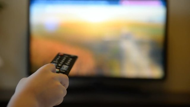 TV remote control in children's hands close-up