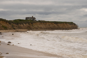 Quaint house sits on a hill overlooking the ocean beach as luxury real estate property