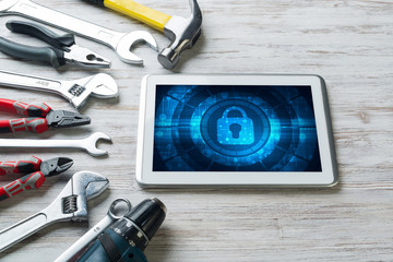 Web security and technology concept with tablet pc on wooden table