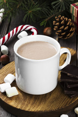 Christmas drink hot chocolate with cream and marshmallows on a wooden background