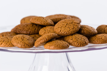 pile of homemade speculaas (type of spiced biscuit made of brown sugar & cinnamon) for the St Nicholas day (Sinterklaas) on white background