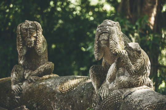 Stone monkeys on the Monkey forest, Ubud. Bali.