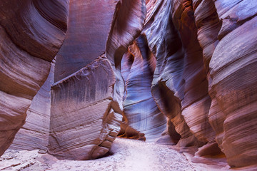 Tall Sandstone Cliff Walls at Narrow Point in Buckskin Gulch, world longest slot canyon that feeds into Paria River in Utah United States USA