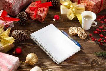  Christmas gifts presents, wish list and christmas decorations on wood background. Christmas lifestyle concept.