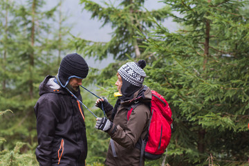 young couple of hikers having good time in autumn mountains 