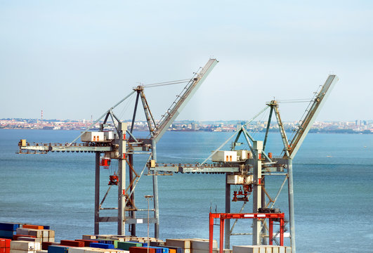 Industrial sea port with cranes and containers.