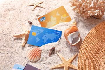Credit cards and shells on sand