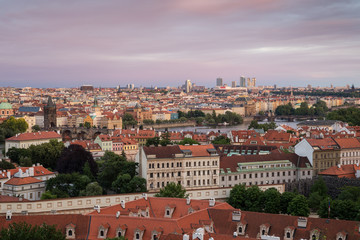 Fototapeta na wymiar View of buildings at Mala Strana (Lesser Town), Old Town and beyond in Prague, Czech Republic, viewed slightly from above at sunset.