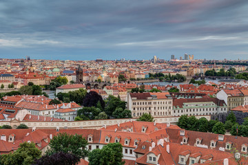 Obraz premium View of buildings at Mala Strana (Lesser Town), Old Town and beyond in Prague, Czech Republic, viewed slightly from above in the early evening.