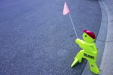 Peculiar Original Traffic Control Sign with Toy Shape Figure on Driveway near Children Playground...