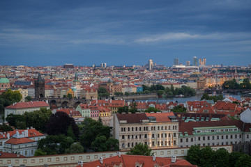 Fototapeta na wymiar View of buildings at Mala Strana (Lesser Town), Old Town and beyond in Prague, Czech Republic, viewed slightly from above at dusk.