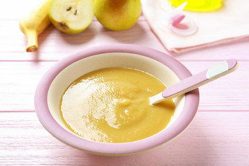 Bowl with baby food on table