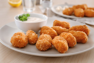 Plate with delicious salmon croquettes on table, closeup
