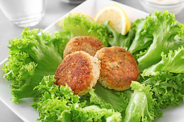 Delicious salmon patties on plate, closeup