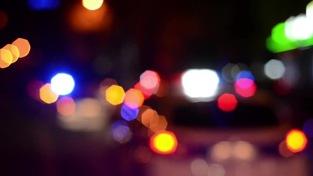 Police emergency lights flash at night. Car accident. Crime scene. Blurred. 