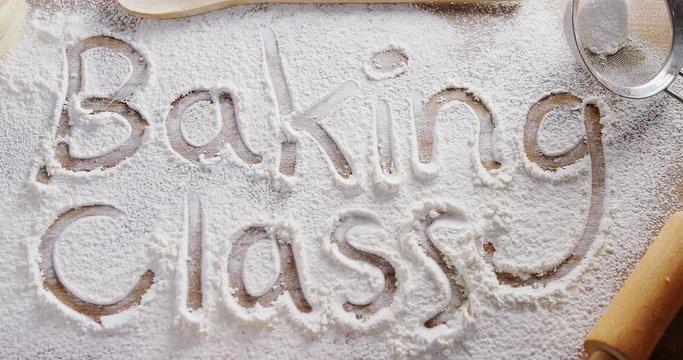 The word baking class written on sprinkled flour 
