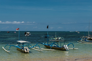 Traditional balinese dragonfly boat on the beach. Jukung fishing boats on Sanur beach, Bali, Indonesia, Asia