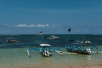 Traditional balinese dragonfly boat on the beach. Jukung fishing boats on Sanur beach, Bali,...