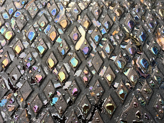 Colourful water drops on metal surface in a shape of rhombus
