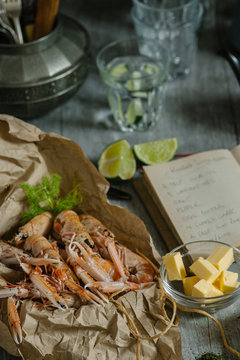 Langoustines on kitchen table with recipe book.