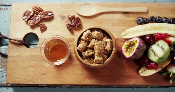 Granola bars in bowl with honey and fruits 