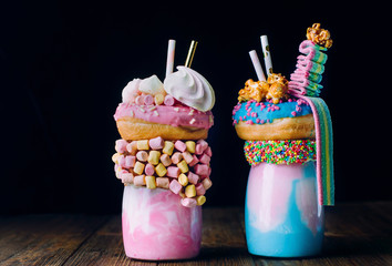 Two freak shakes over black background with blank space for text