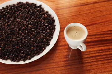 Cup of coffee and roasted coffee beans