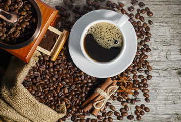Coffee cup with coffee bag on wooden table. View from top.