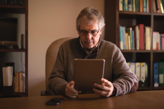 Man Using Digital Tablet At Desk