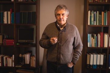 Senior man standing in drawing room