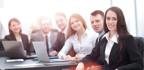 Elegant co-workers looking at camera during meeting in office