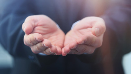 Businessman give you secret about successful business. Giving and protecting gesture. Blue formal wear and background.