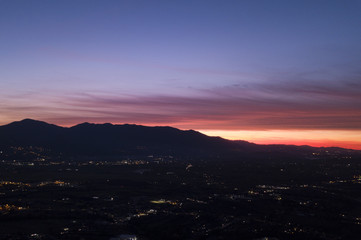 Aerial view of an incredible sunset behind the Italian mountains