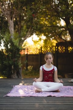 Girl practicing yoga in the park 