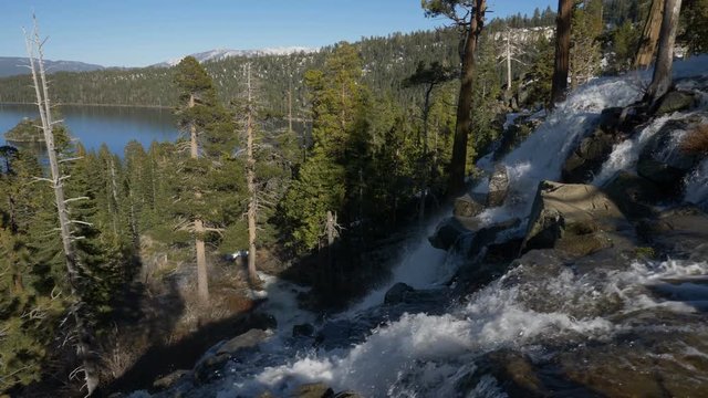 Slow motion (60 fps rendered at 30 fps) panning view of the upper portion of Lower Eagle Falls, with Emerald Bay, Lake Tahoe, California, in the background.