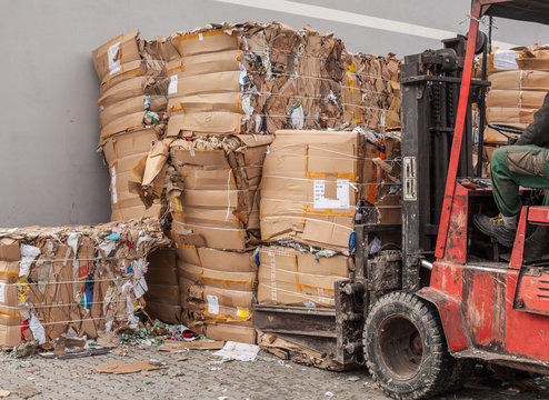 Forklift Lifting Pallets of Old Paper